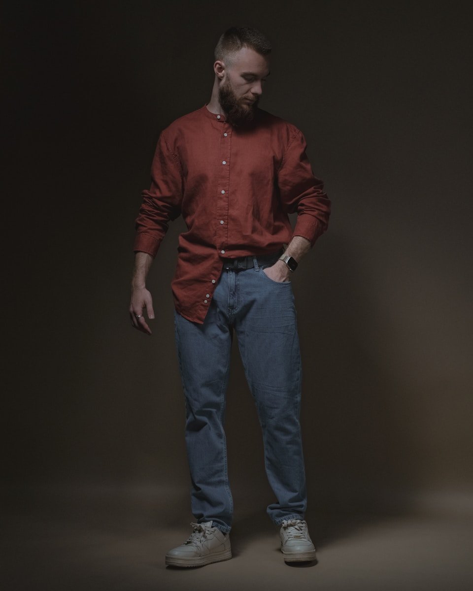 a man in a red shirt and blue jeans