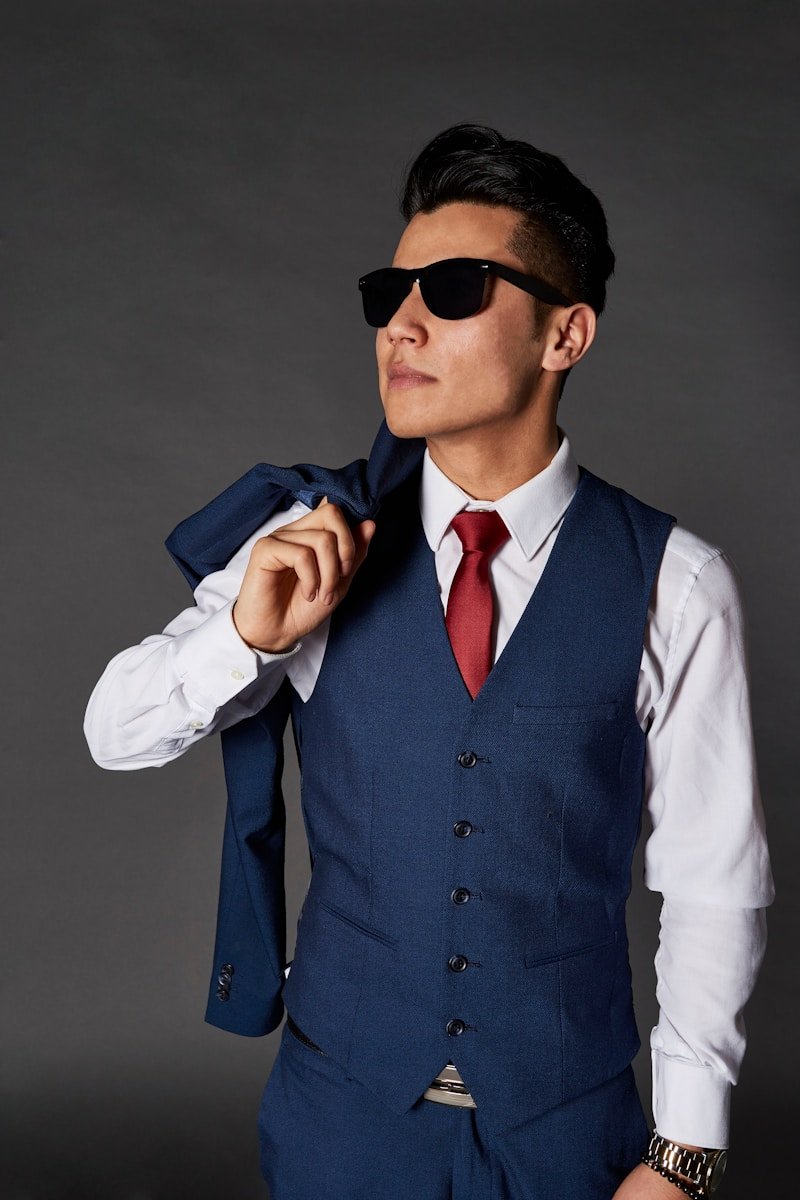 man carrying blue jacket while looking sideways